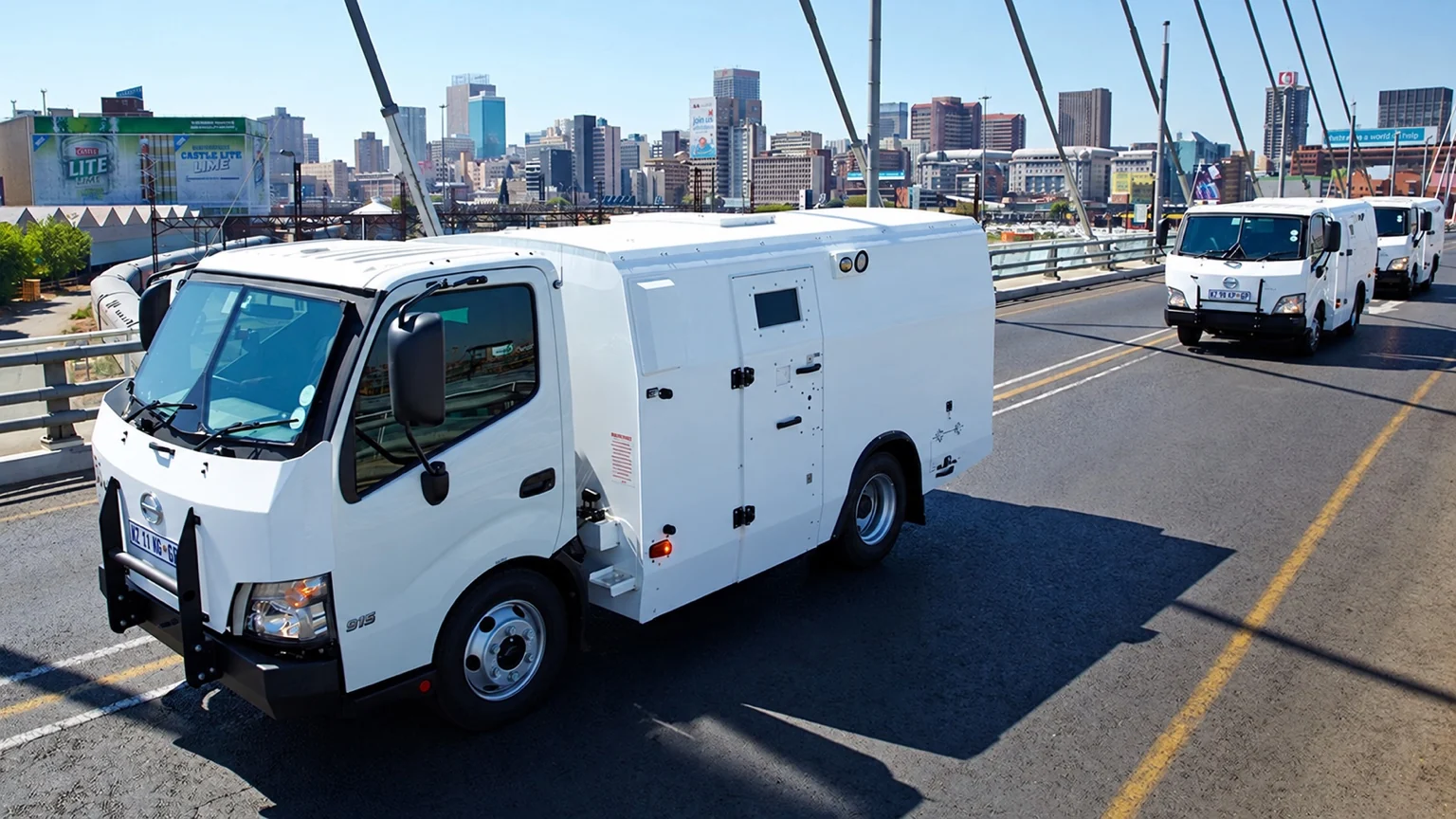 White Hino armoured valuables-in-transit vehicle on a city bridge